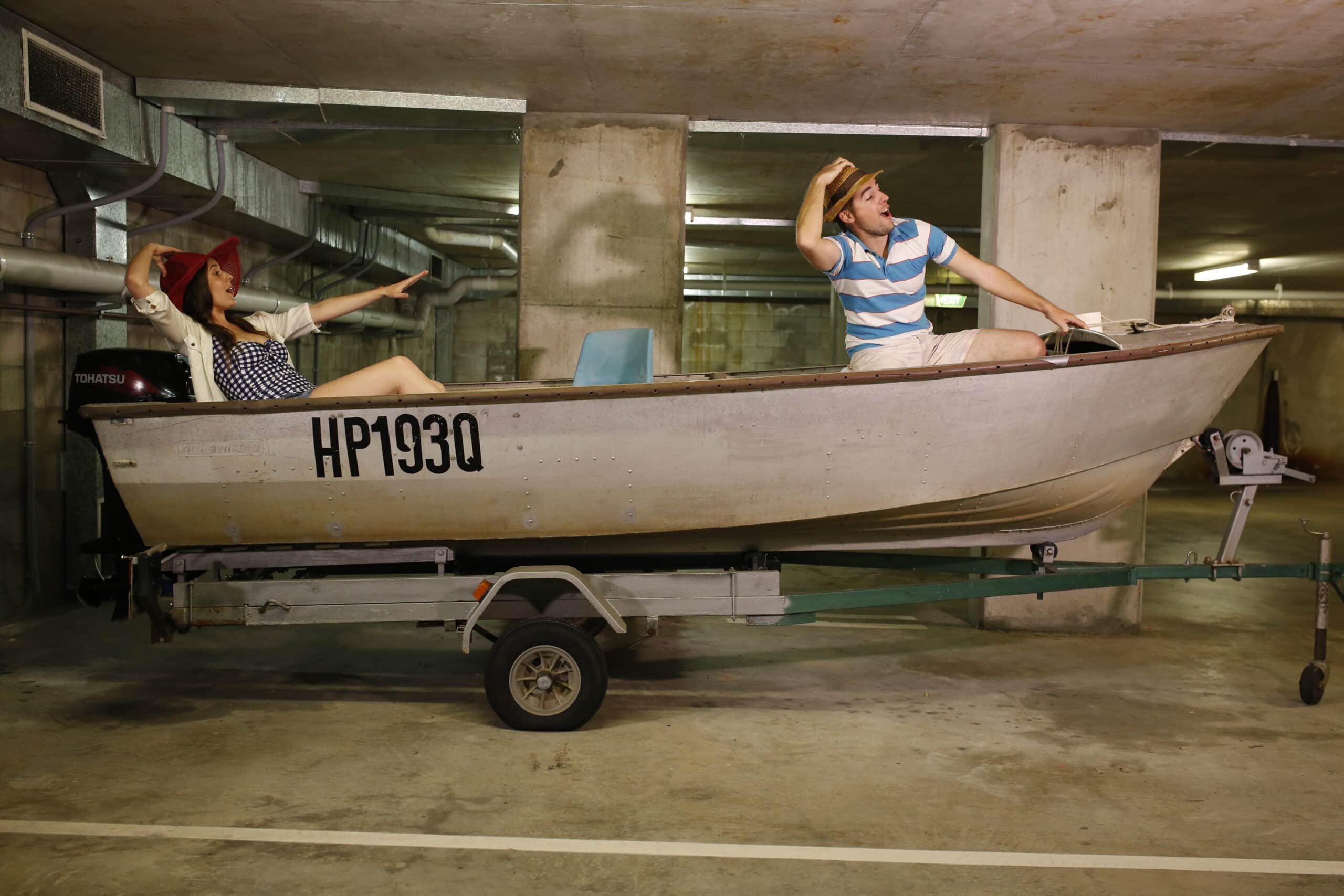 Shaun and TJ brand shoot — boat on a trailer in the basement.